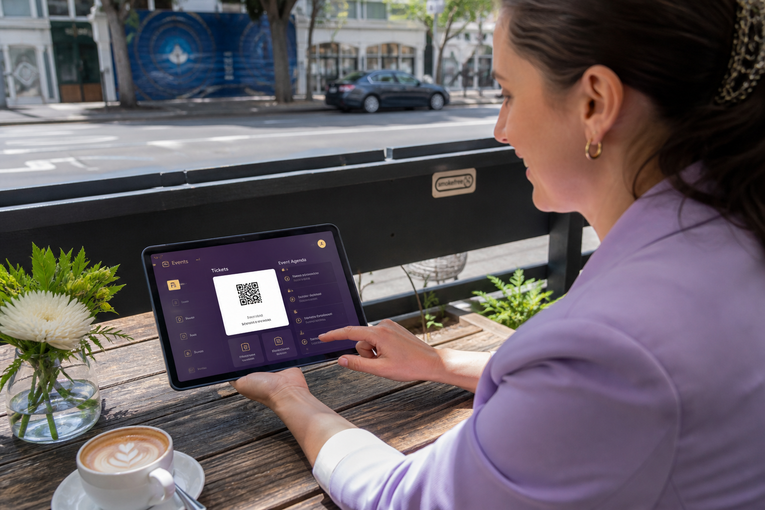 Sunny Auckland cafe with an organiser reviewing an original event app concept on a tablet