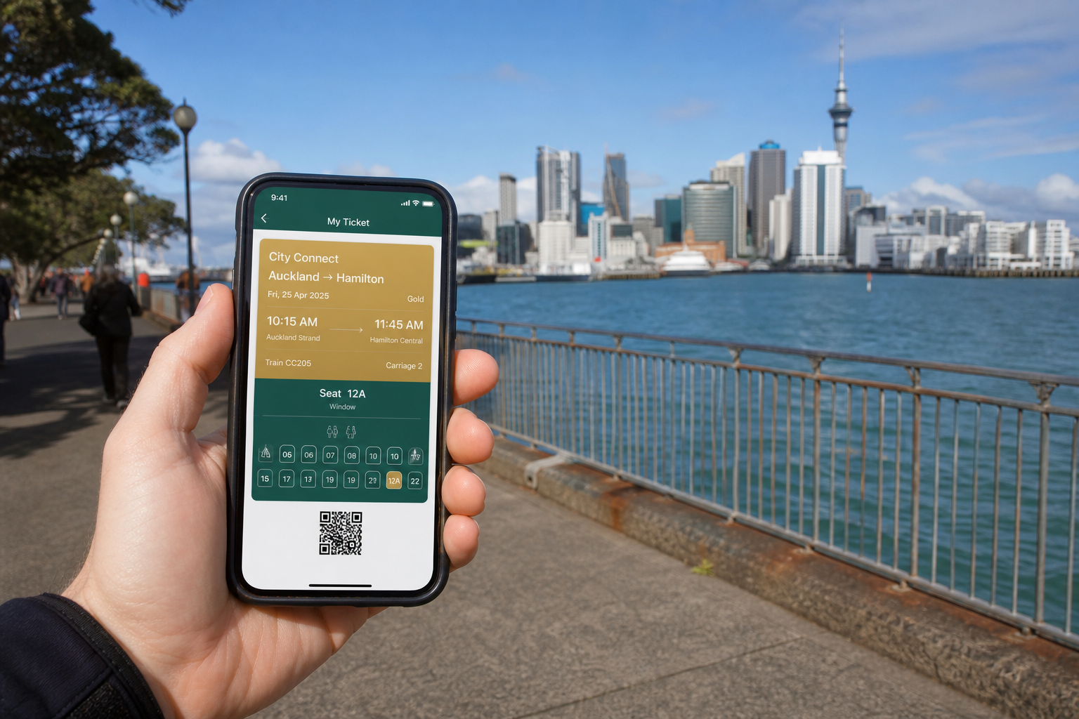 Sunny Auckland waterfront with a smartphone showing an original train ticket and seat selection app